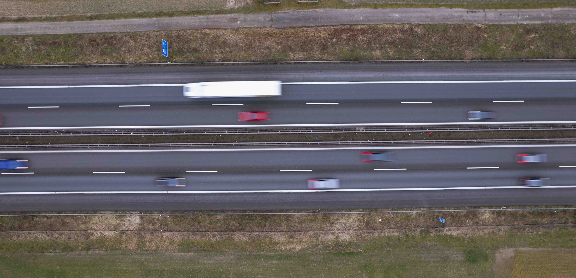 Aerial view of trucks moving freight on a divided highway