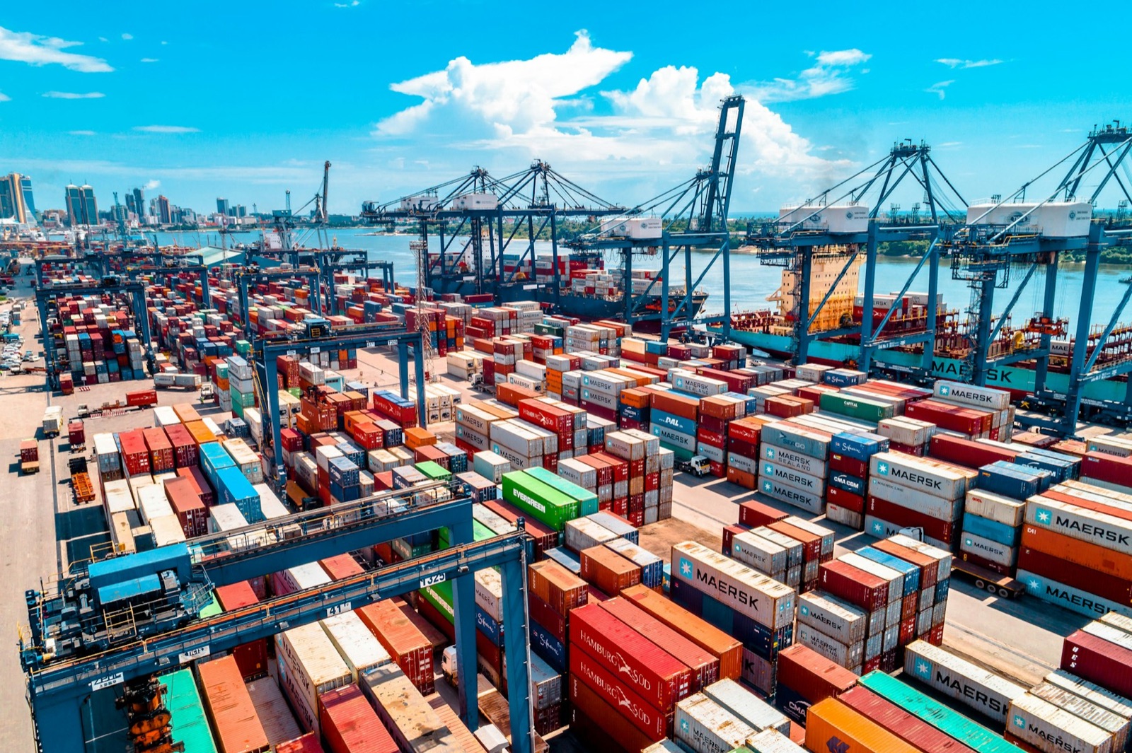 Aerial view of a marine container terminal with stacked containers and ship to shore cranes